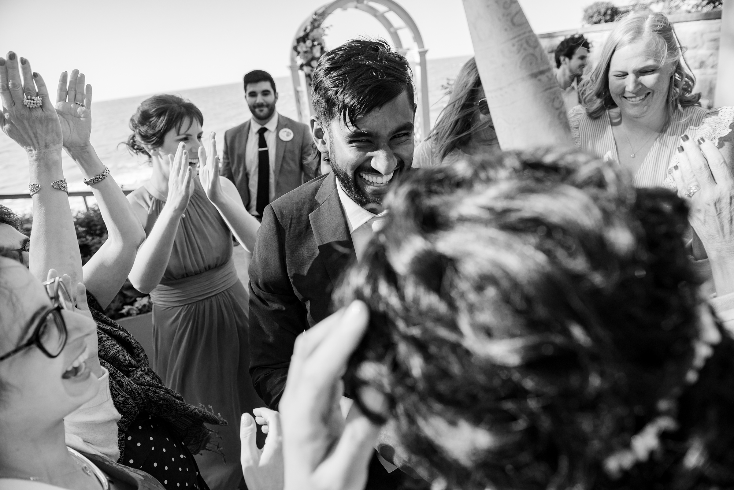 Groom celebrates and dances with his wife on their wedding day in Rocky River. Photo taken by Cleveland Wedding Photographer Aaron Aldhizer