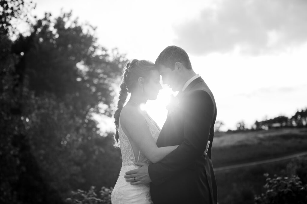 Bride and groom embrace each other and at sunset on their wedding day at Blue Heron Brewery & Event Center. Photo taken by Cleveland Wedding photographer Aaron Aldhizer