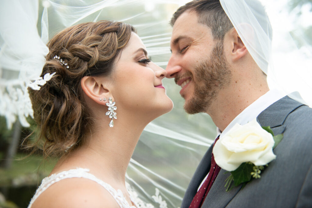 bride and groom happily lean in to kiss on their wedding day in Solon, Ohio. Photo taken by Cleveland wedding photographer Aaron Aldhizer