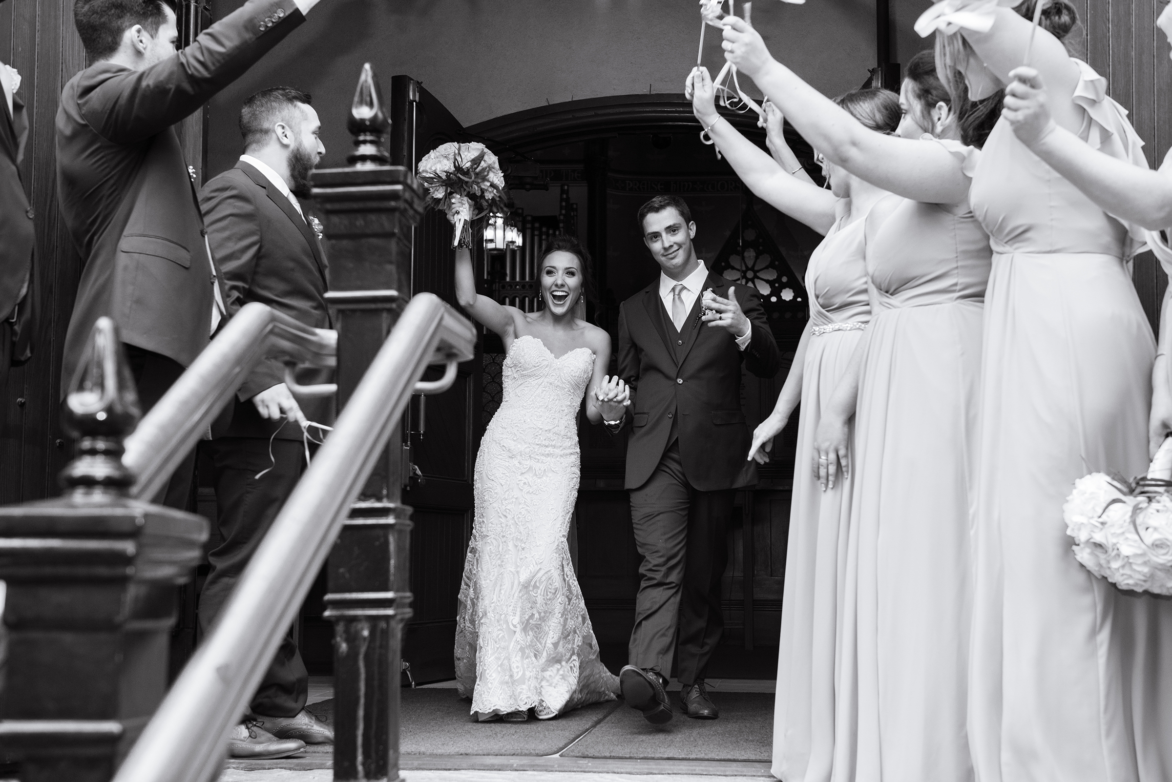 Beautiful bride and her groom walk out of a Cleveland Church on their wedding day. Photo taken by Cleveland Wedding Photographer Aaron Aldhizer