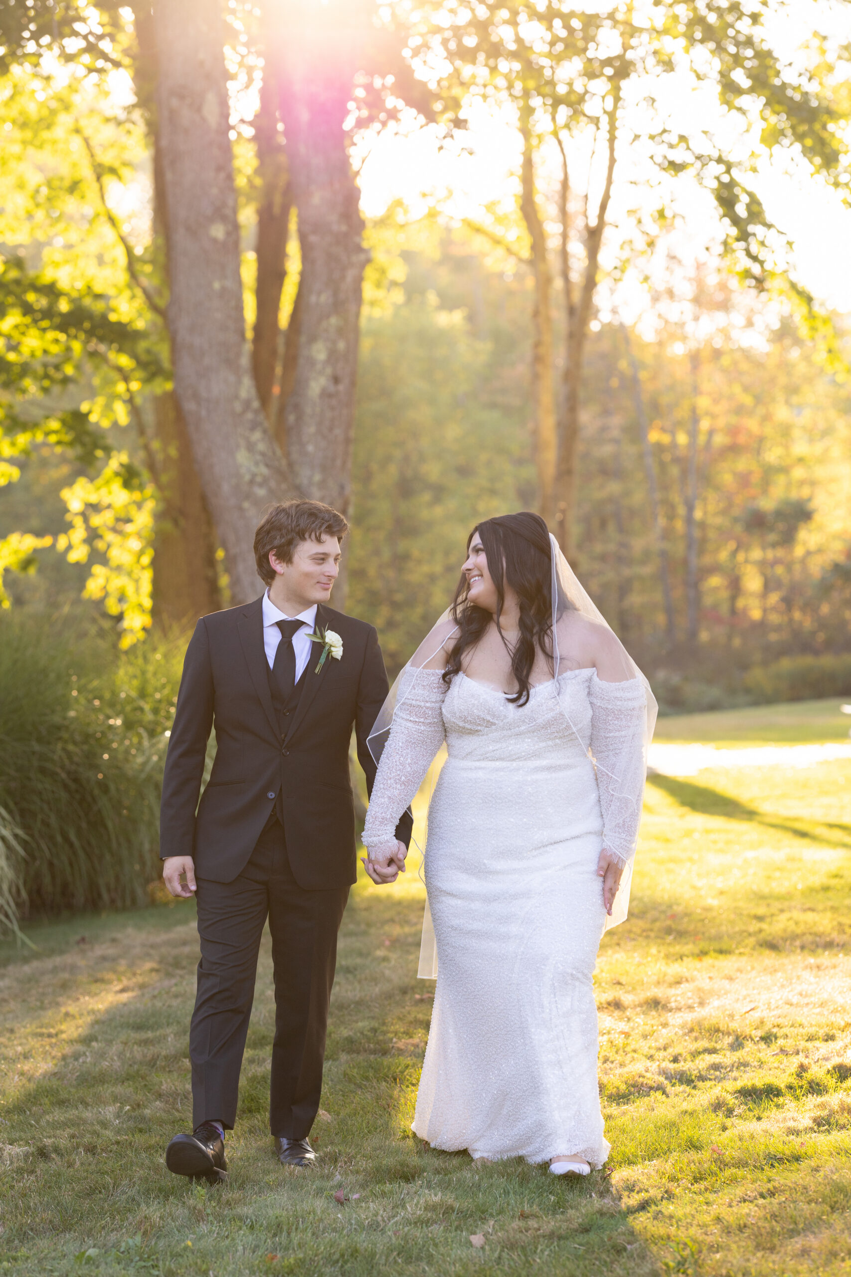 Bride and groom hold hands while looking at each other and taking in the moment alone on their wedding day at the Sun Valley in Chagrin Falls, Ohio. Photographed by Aaron Aldhizer